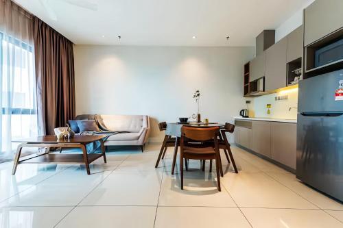 a kitchen and living room with a table and chairs at Geo 38 Residence Genting Highlands in Genting Highlands