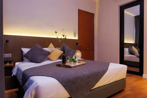 a bedroom with a large bed with a tray on it at Geo 38 Residence Genting Highlands in Genting Highlands