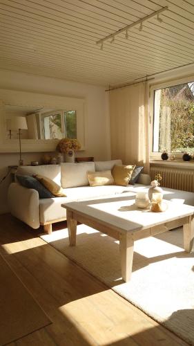 a living room with a couch and a coffee table at Ferien am See in Möhnesee