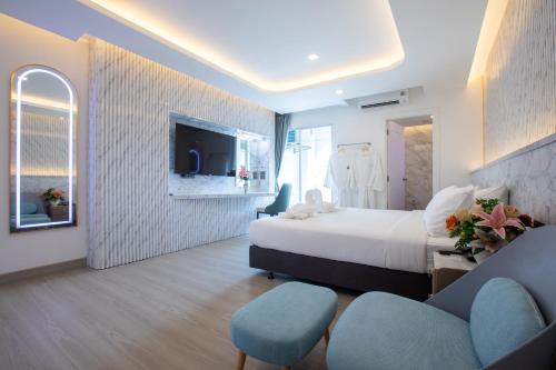 a hotel room with a bed and a tv at Airbus Hotel At Phawana Station in Bangkok