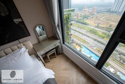 a hotel room with a bed and a large window at Sarene Lumiere Riverside Thao Dien in Ho Chi Minh City