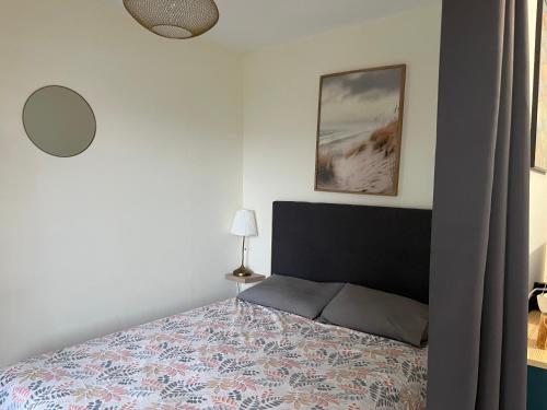 une chambre avec un lit et un tableau au mur dans l'établissement Appartement Havre de Quiberon, à Quiberon