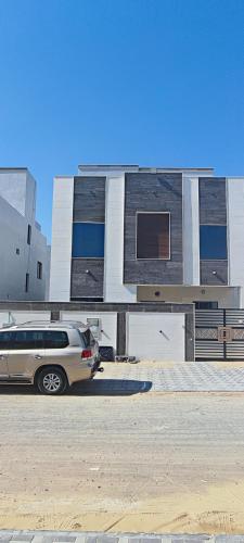 a van parked in front of a building at Villa 6 in Ajman