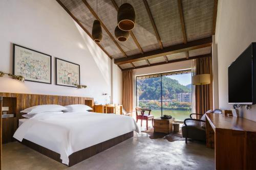 Postel nebo postele na pokoji v ubytování Huangshan Shanshuijian Wei Boutique Hotel