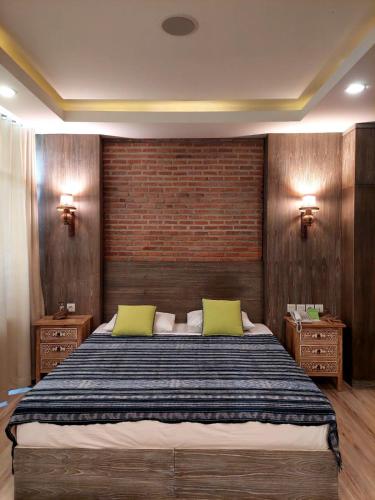 a bedroom with a large bed with two yellow pillows at Apartemen Senayan in Jakarta