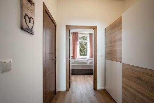 a hallway with a room with a bed and a window at Altstadt Residenz in Lübeck