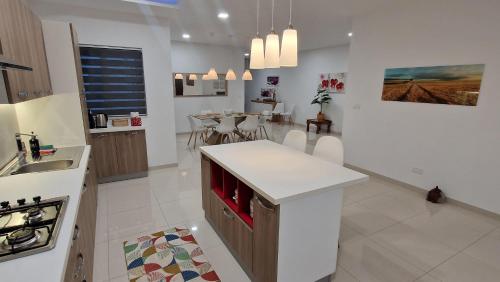 a white kitchen with a counter and a sink at Carousel Apartments in Qrendi