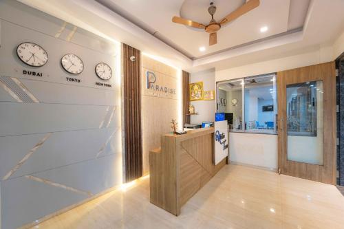 a lobby with clocks on the wall and a counter at Treebo Winter Town Venna Lake in Mahabaleshwar