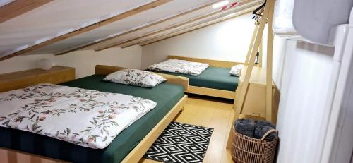 two beds in a room with a bunk bed at Apartments Štrancar wines in Ajdovščina