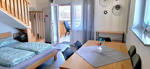 a small apartment with a table and a bed and a room at Apartments Štrancar wines in Ajdovščina