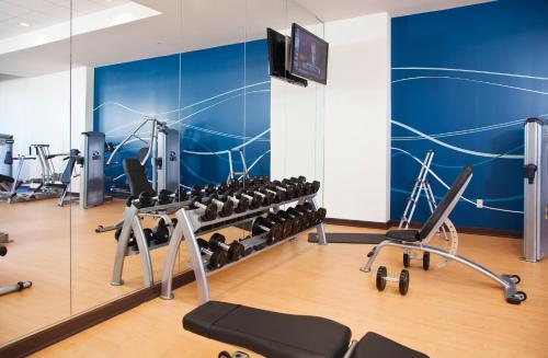 a gym with rows of exercise equipment and a mirror at Wyndham Grand Orlando Resort Bonnet Creek in Orlando