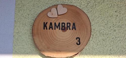 a wooden skateboard with the word karma written on it at Apartments Štrancar wines in Ajdovščina