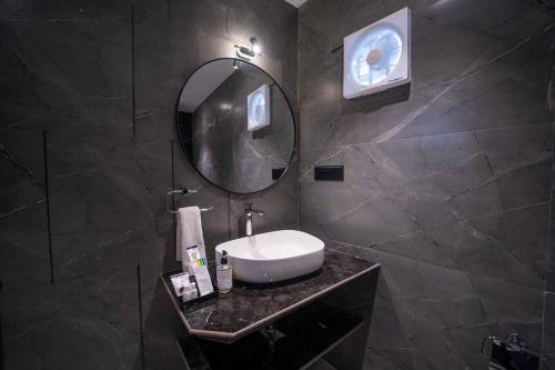 a bathroom with a sink and a mirror at Treebo Winter Town Venna Lake in Mahabaleshwar