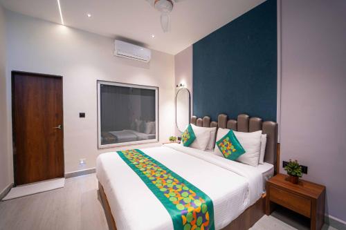 a bedroom with a large bed and a large window at Treebo Winter Town Venna Lake in Mahabaleshwar