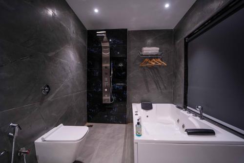 a bathroom with a white toilet and a sink at Treebo Winter Town Venna Lake in Mahabaleshwar