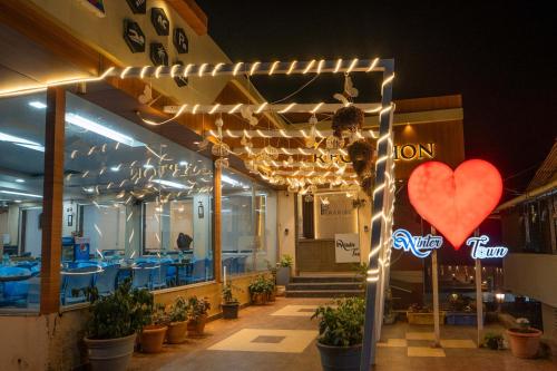 a restaurant with a heart sign in front of it at Treebo Winter Town Venna Lake in Mahabaleshwar