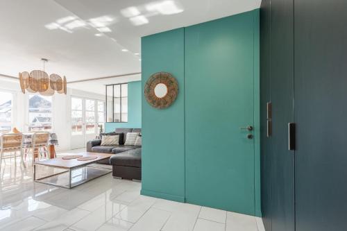 - un salon avec une porte bleue et un canapé dans l'établissement Le Charles Albert - Appartement confortable proche du centre ville, à Annecy