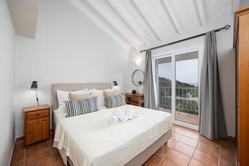 Postel nebo postele na pokoji v ubytování Villa Gardenia
