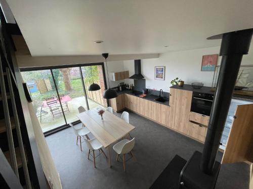 a kitchen and dining room with a table and chairs at Grange Plouer centre entre St Malo et Dinan in Plouër-sur-Rance