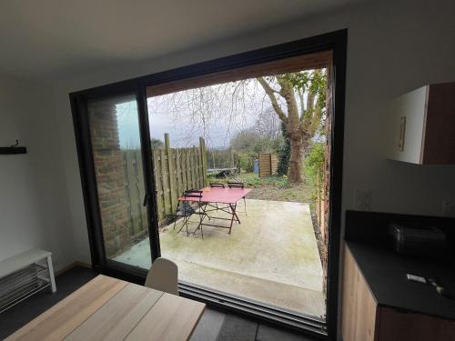 a room with a sliding glass door leading to a patio at Grange Plouer centre entre St Malo et Dinan in Plouër-sur-Rance