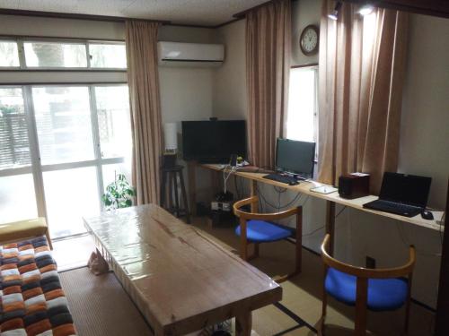 a room with two desks with computers and a table at Kajikaen - Vacation STAY 57948v in Kawazu
