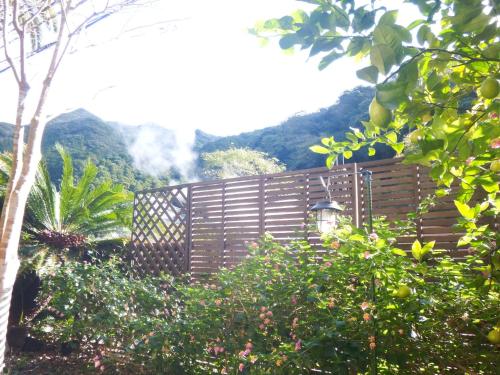 a wooden fence with a mountain in the background at Kajikaen - Vacation STAY 57948v in Kawazu