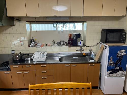 a kitchen with a sink and a refrigerator at Kajikaen - Vacation STAY 57948v in Kawazu