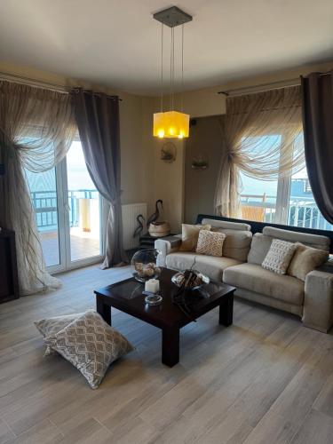 a living room with a couch and a coffee table at DiamondSunsetApartments in Perea