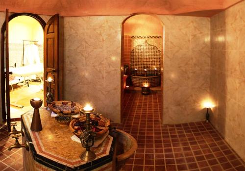 a hallway with a table and a fireplace in a room at Palais Dar Ouladna in Marrakech