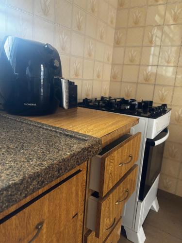 a kitchen with a stove and a counter top at ALAMEDA iNN in Poços de Caldas
