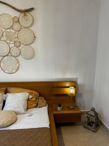 a bedroom with a bed with plates on the wall at DiamondSunsetApartments in Perea