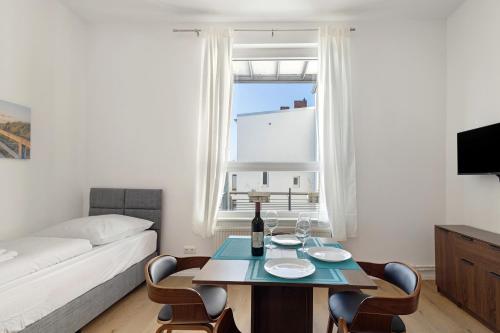 a living room with a table and chairs and a couch at Altstadt Residenz in Lübeck