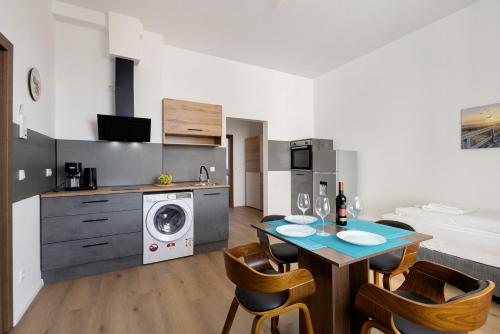 a kitchen and living room with a table and chairs at Altstadt Residenz in Lübeck