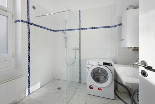 a washing machine in a bathroom with a shower at Altstadt Residenz in Lübeck