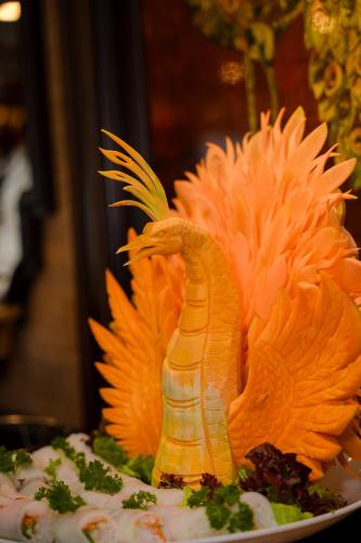 an orange cake with a phoenix on top of it at Indochine Grand Lan Ha Bay in Ha Long