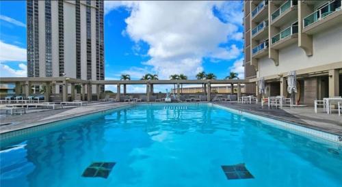 a large swimming pool with blue water in a building at Ala Moana Hotel by Final Form in Honolulu