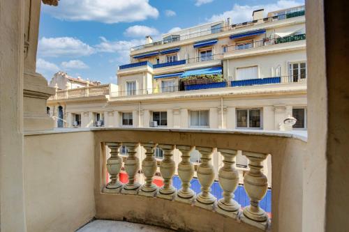 un balcon avec un bâtiment en arrière-plan dans l'établissement L'Écrin Blanc Niçois - Welkeys, à Nice