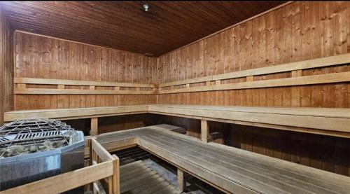 a large empty sauna with wooden walls and benches at Ala Moana Hotel by Final Form in Honolulu