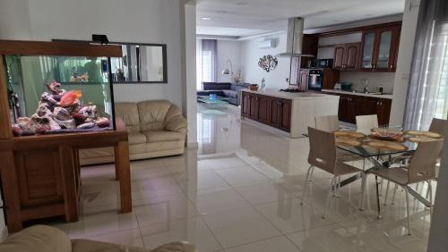 a living room and a kitchen with a fish tank at Carousel Apartments in Qrendi