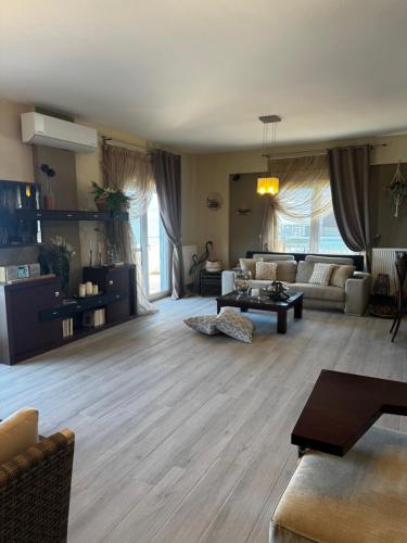 a living room with a couch and a table at DiamondSunsetApartments in Perea