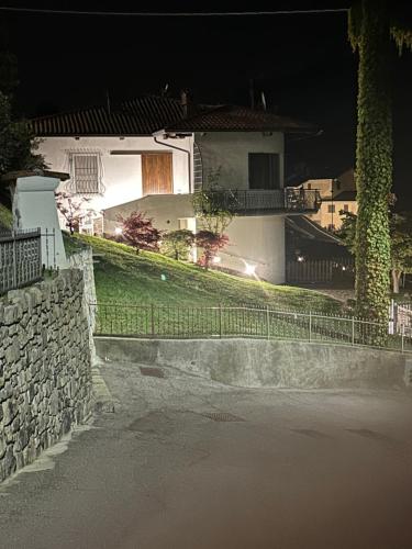 a house with a fence in front of a street at Casa Vacanza SK in Bianzano