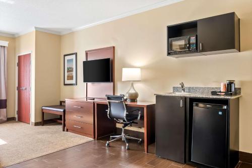a hotel room with a desk and a chair at Comfort Suites Panama City near Tyndall AFB in Panama City