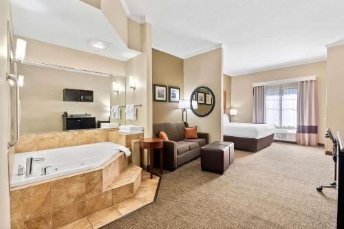 a hotel room with a tub and a bed at Comfort Suites Panama City near Tyndall AFB in Panama City