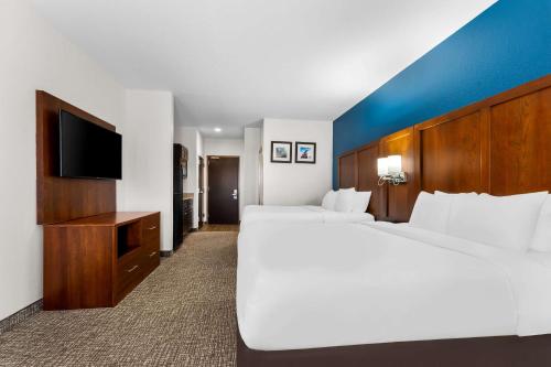a hotel room with two beds and a flat screen tv at Comfort Inn & Suites Augusta West Near Fort Eisenhower in Augusta