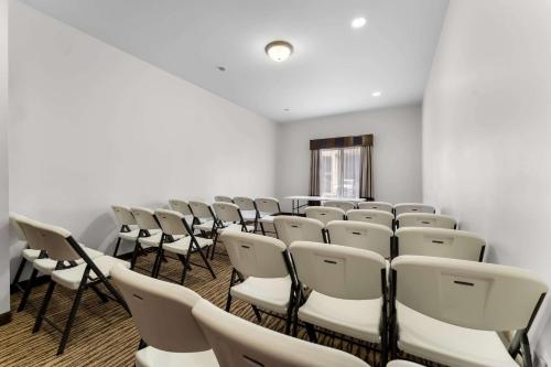 an empty room with rows of chairs and a spotlight at Comfort Inn & Suites Augusta West Near Fort Eisenhower in Augusta