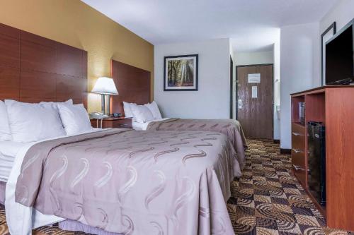 a hotel room with two beds and a television at Quality Inn Sycamore - DeKalb in Sycamore
