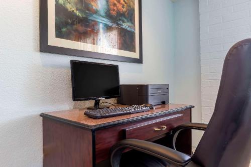 a computer sitting on top of a desk with a chair at Quality Inn Sycamore - DeKalb in Sycamore