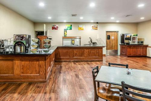 a room with a counter with a table and a kitchen at Quality Inn & Suites Hannibal West in Hannibal