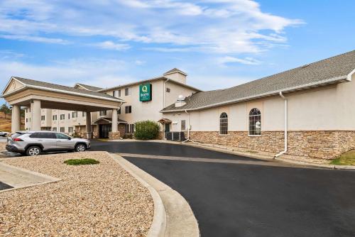 a hotel with a car parked in a parking lot at Quality Inn near Monument Health Rapid City Hospital in Rapid City