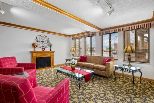 a living room with red furniture and a fireplace at Quality Inn near Monument Health Rapid City Hospital in Rapid City